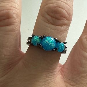 Black metal with man-made Australian opal ring